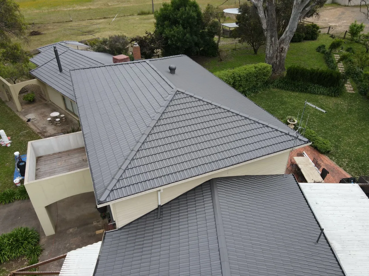 Ridges and hips up close Close aerial view of recoated concrete tiles with crisp, even ridge and hip capping on a restored roof, tile roof restoration by Roof Restoration Services Bendigo